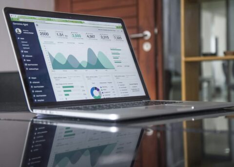 Laptop displaying financial analytics charts for a finance close review