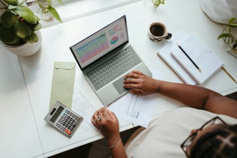 Finance professional reviewing spreadsheet data on a laptop for cash flow statement analysis