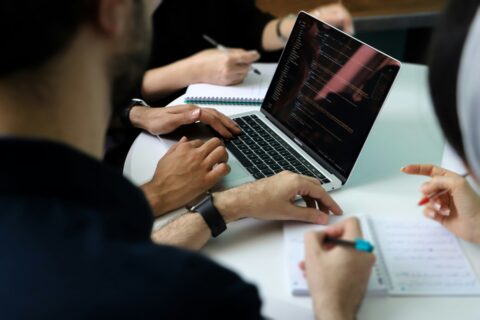 Finance team reviewing financial reports and spreadsheet reconciliations during a meeting