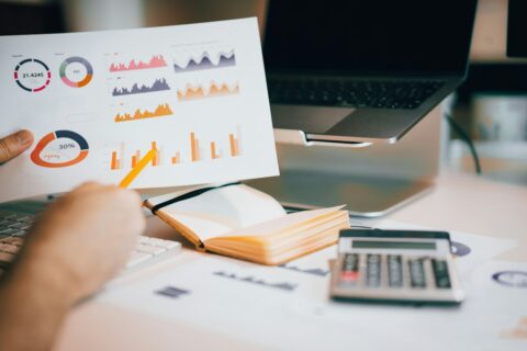 Finance professional reviewing financial information on a laptop for foreign currency close analysis