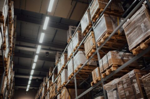 Cardboard boxes stored on warehouse racks, illustrating goods receipt and invoice reconciliation controls.